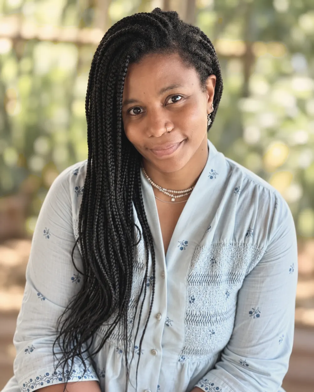 Tima Camara, smiling, in natural light